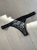 black leopord thong on wooden floor