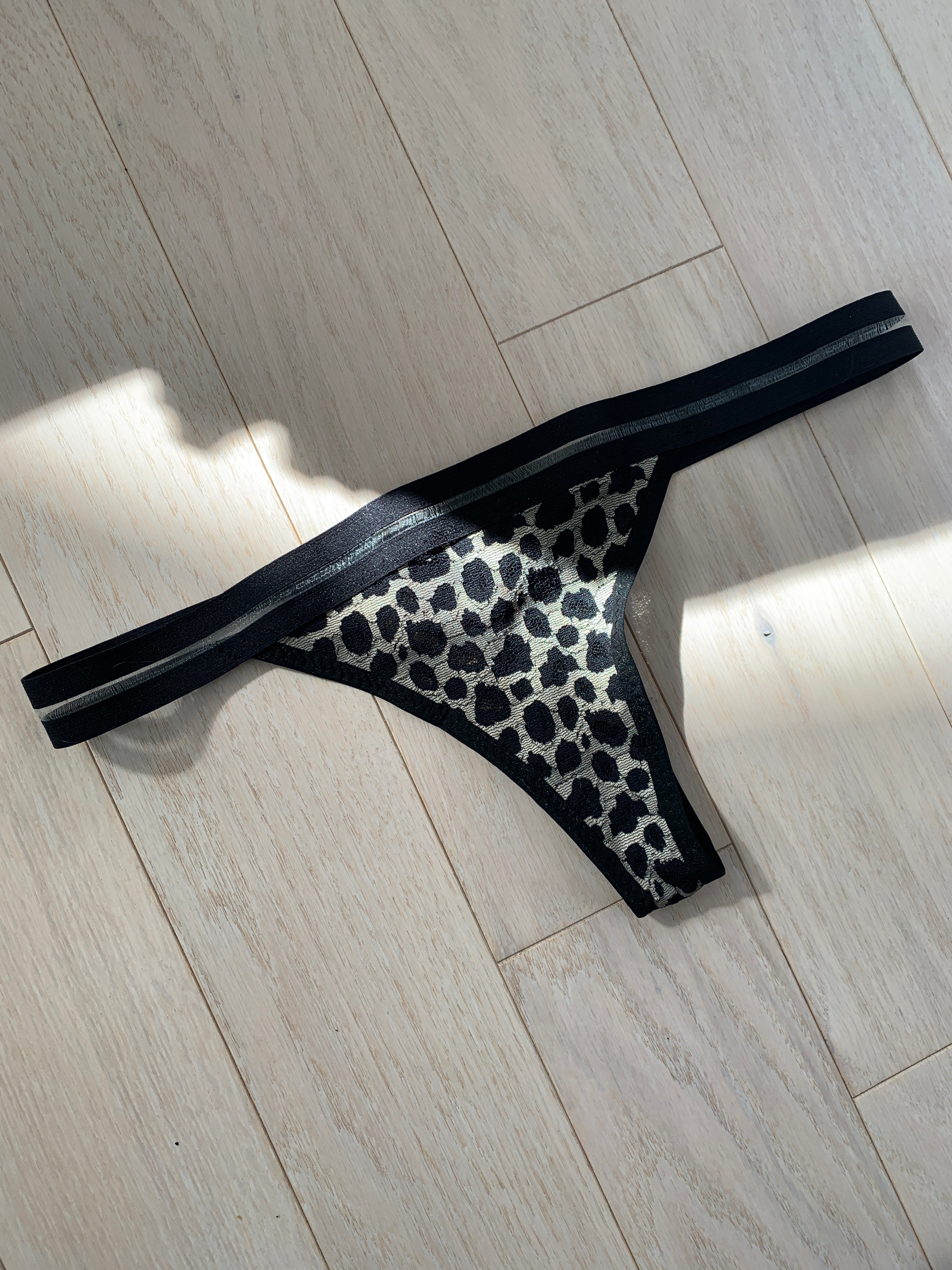 black leopord thong on wooden floor
