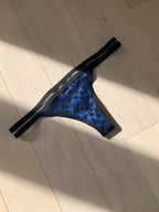 blue and black leopard undies against a wooden floor