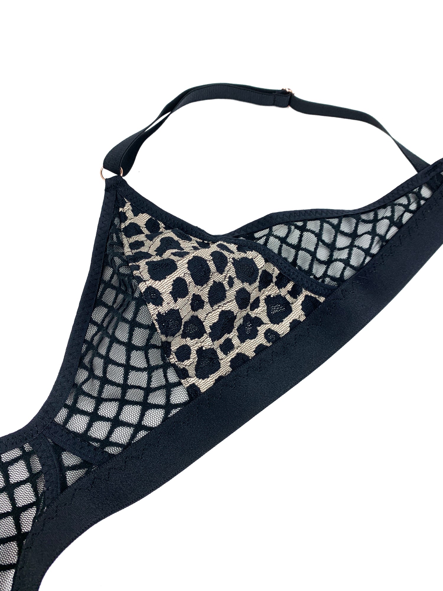 black leopard and mesh bra lingerie against white background