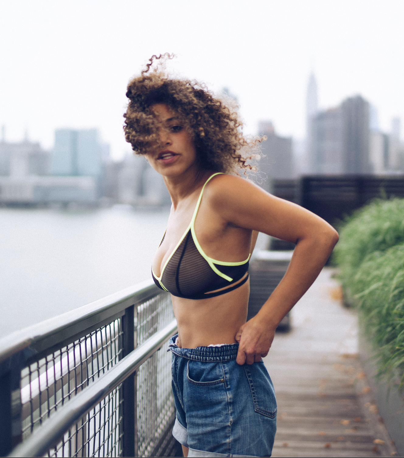 Girl outside with black lace and neon trim bralette 