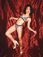 woman wearing a silver print underwear set while dancing 